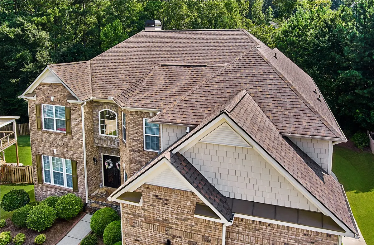 Warm shingles on a brick home — roof detail